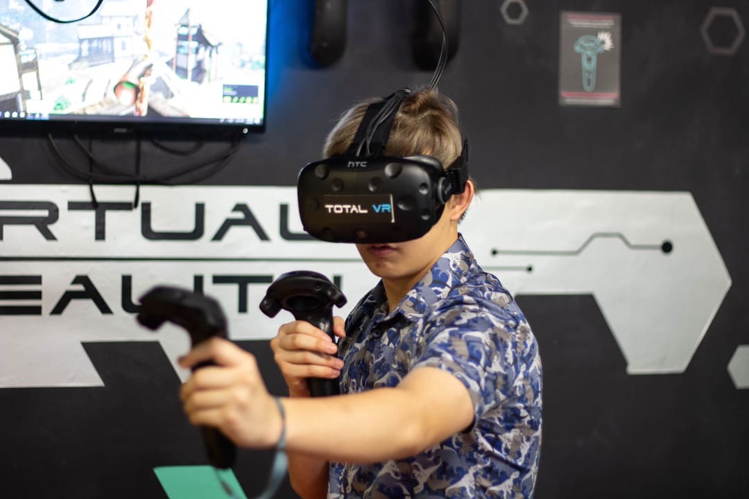 Guest wearing a Total VR branded HTC Vive headset